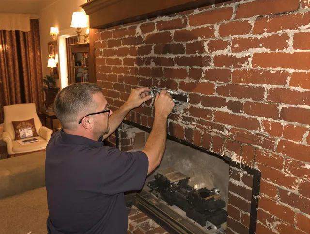 Bloomfield Chimney Sweep expert fixing a fireplace in Bloomfield, CT